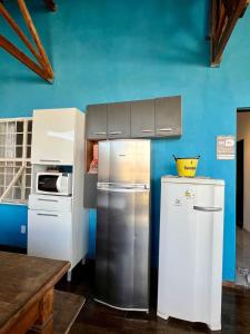 a kitchen with a refrigerator and a stove at Chácara Lobos in Sorocaba