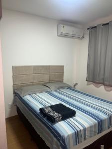 a bedroom with a bed with a blue and white blanket at MaM TORRE DOS HOLANDESES in São Luís +27 photos
