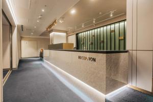a lobby with a reception desk in a building at Meworld Hotel - Taipei Main Station in Taipei