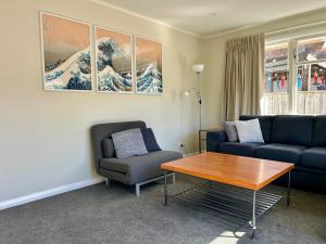 a living room with a couch and a table at Hanmer Time in Hanmer Springs