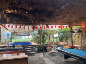 a pool hall with tables and ping pong tables at Big J Hostel in Ninh Binh