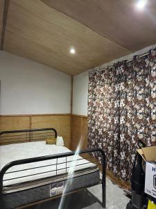 a bedroom with a bed and a floral wall mural at Rancho Las Bugambilias in Arteaga
