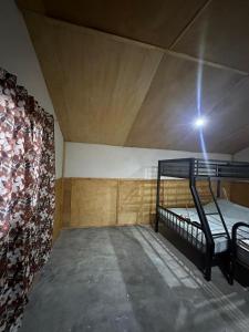 a bedroom with a bunk bed in a room at Rancho Las Bugambilias in Arteaga