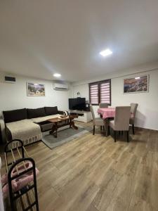 a living room with a couch and a table at Apartmani Fenix 29 in Ljubovija