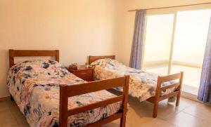 a bedroom with two beds and a window at La soñada in Salta
