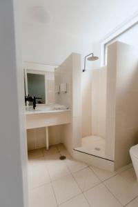 a bathroom with a sink and a toilet and a mirror at Canberra Park Motel in Canberra