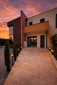 a house with a sunset in the background at Villa Jonchère in Chanteloup-en-Brie