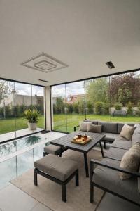 a living room with a couch and a table at Villa Jonchère in Chanteloup-en-Brie