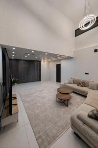 a large living room with a couch and a table at Villa Jonchère in Chanteloup-en-Brie