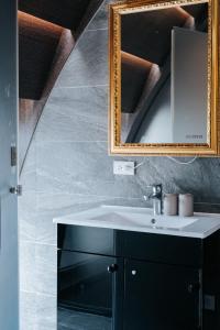 a bathroom with a sink and a mirror at Meworld Hotel - Taipei Main Station in Taipei +32 photos