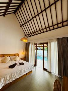a bedroom with a bed and a pool at VILLA Santay byAdiba in Gili Islands +74 photos