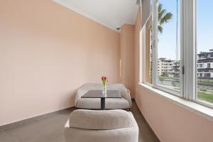 a room with a table and a chair and a window at The Cliff Suites in Golem