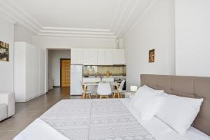 a bedroom with a bed and a table with chairs at The Cliff Suites in Golem
