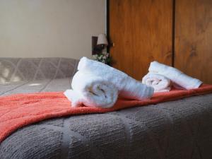 two rolls of towels sitting on a bed at Aroma de campo in Chascomús +15 photos