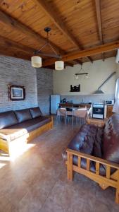 a living room with a couch and a kitchen at Aroma de campo in Chascomús