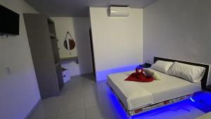 a bedroom with a bed with a red shoes on it at Pousada sonho real in Barreirinhas