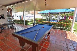 a pool table on a tiled floor in a patio at Hotel terranova in Melgar +22 photos