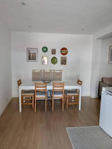 a dining room with a white table and chairs at Casa do Picadeiro in Elvas +9 photos