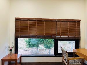 a window with a wooden blind in a room at Núp Gió Cottages in Ấp Mỹ Hải