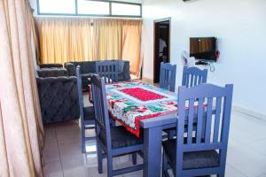 a dining room with a table and chairs with a table and a table and chairs at villa km19 in Assinie