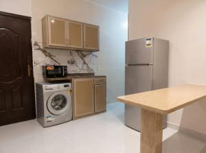 a kitchen with a refrigerator and a washing machine at Soly Apartments in Hurghada