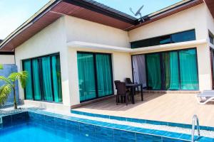 a villa with a swimming pool and a house at villa km19 in Assinie