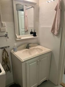 a white bathroom with a sink and a mirror at Vacation Home in Oslo in Oslo +12 photos