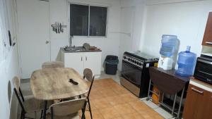a small kitchen with a table and a sink at Residencia cercana ENGIE in Tocopilla