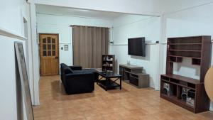 a living room with a couch and a television at Residencia cercana ENGIE in Tocopilla +3 photos