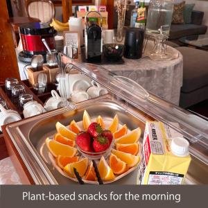 a plate of fruit with strawberries on top of it at Sanga Nikko - An Authentic Japanese Guesthouse Experience in Nikko