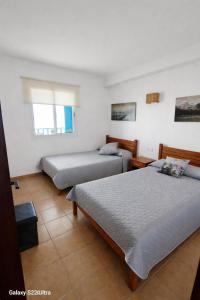 a bedroom with two beds and a window at Spacious Apartment with views to sea and pool Kabila vista Families only in Marina Smir +37 photos