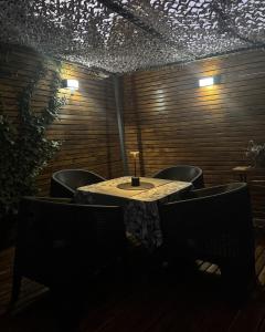 a table and chairs in a room with lights at Aromos Lodge- Chacras de Coria- in Ciudad Lujan de Cuyo +33 photos