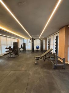 a gym with treadmills and benches in a room at Studio nascente na Pituba in Salvador