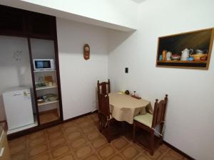 a room with a table and chairs and a refrigerator at Departamento CRIMAR in Viedma +3 photos