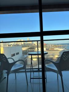 a view of a table and chairs on a balcony at Studio nascente na Pituba in Salvador
