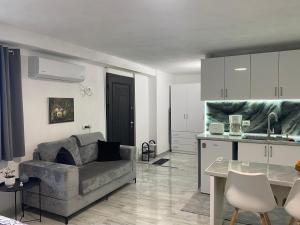 a living room with a couch and a kitchen at Tiny home at the castle in Shkodër