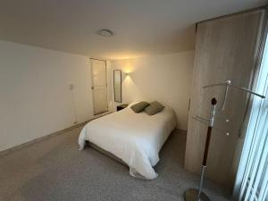 a bedroom with a white bed and a window at Apartment near Azteca Stadium- Coyoacan in Mexico City