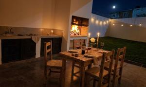 a wooden table and chairs in a kitchen with a fireplace at La soñada in Salta