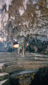 a couple of people standing on stairs in a cave at Poseidon White Sand Resort & Cave in Santa Rosa +25 photos