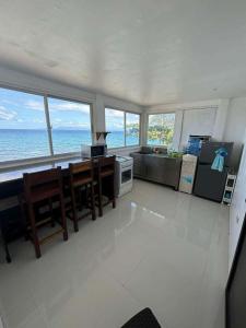 a large kitchen with a view of the ocean at Poseidon White Sand Resort & Cave in Santa Rosa
