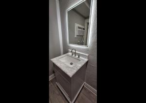 a bathroom with a sink and a mirror at Rainbow Motel in Summit