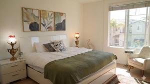 a bedroom with a bed and a chair and a window at Hidden Coastal Gem Between Malibu & SB in Oxnard