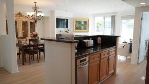 a kitchen with a counter and a dining room at Hidden Coastal Gem Between Malibu & SB in Oxnard