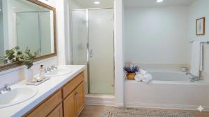 a bathroom with a tub and two sinks and a shower at Hidden Coastal Gem Between Malibu & SB in Oxnard +5 photos
