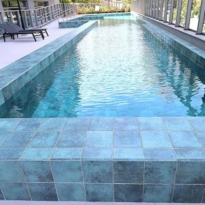 a swimming pool with a bench next to it at MOOD Modern Studio, Central Parque in Porto Alegre