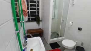 a bathroom with a sink and a toilet and a shower at Vila Santa Eulália Hostel in Pelotas +33 photos