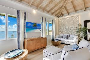a living room with white furniture and a view of the ocean at Villa Serena Water Island in Water Island