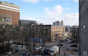 a view of a city street with a bus at mtlFlats - Condotel Le Luxe in Montreal