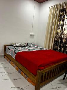 a bedroom with a bed with a red blanket at brothers holidayas vagamon in Vagamon +4 photos