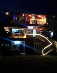 a building with a staircase in front of it at night at brothers holidayas vagamon in Vagamon